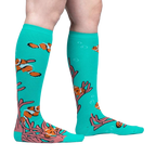 Lifestyle shot showing the 'Friends with Benefish' knee-high socks on a person's legs against a light grey background.