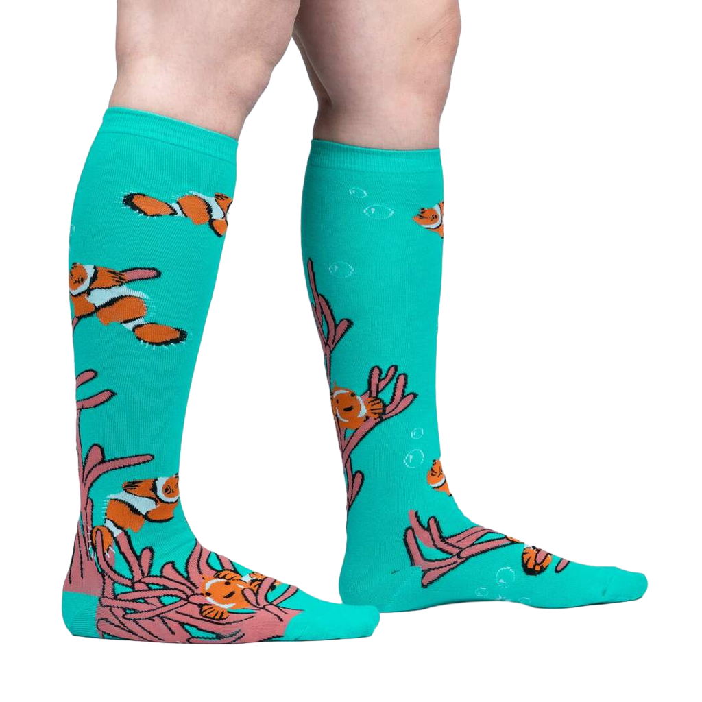 Lifestyle shot showing the 'Friends with Benefish' knee-high socks on a person's legs against a light grey background.