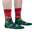 Lifestyle shot of a person wearing the Dinosaur Days Glow socks, showing the socks on their legs.