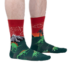Lifestyle shot of a person wearing the Dinosaur Days Glow socks, showing the socks on their legs.