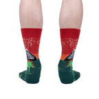 Back view of the Dinosaur Days Glow socks on a person's legs, highlighting the full design.