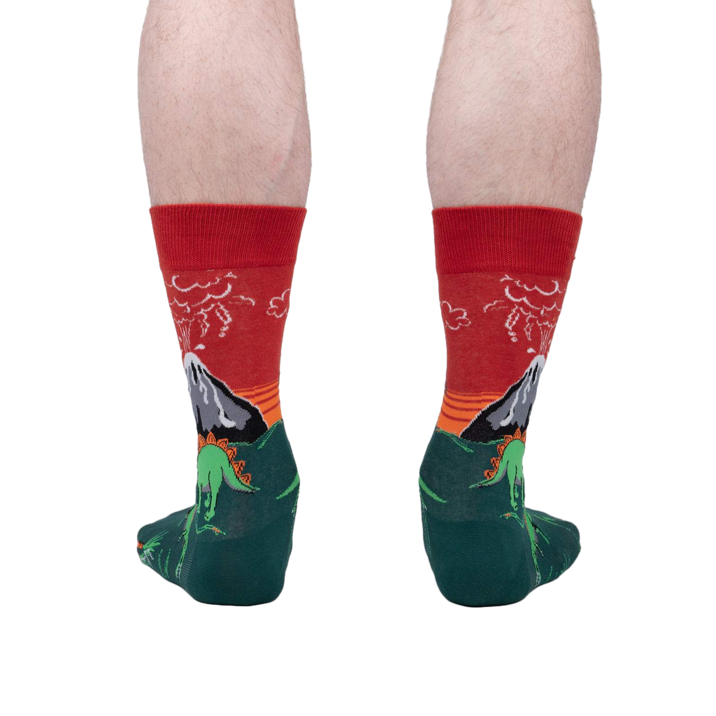 Back view of the Dinosaur Days Glow socks on a person's legs, highlighting the full design.