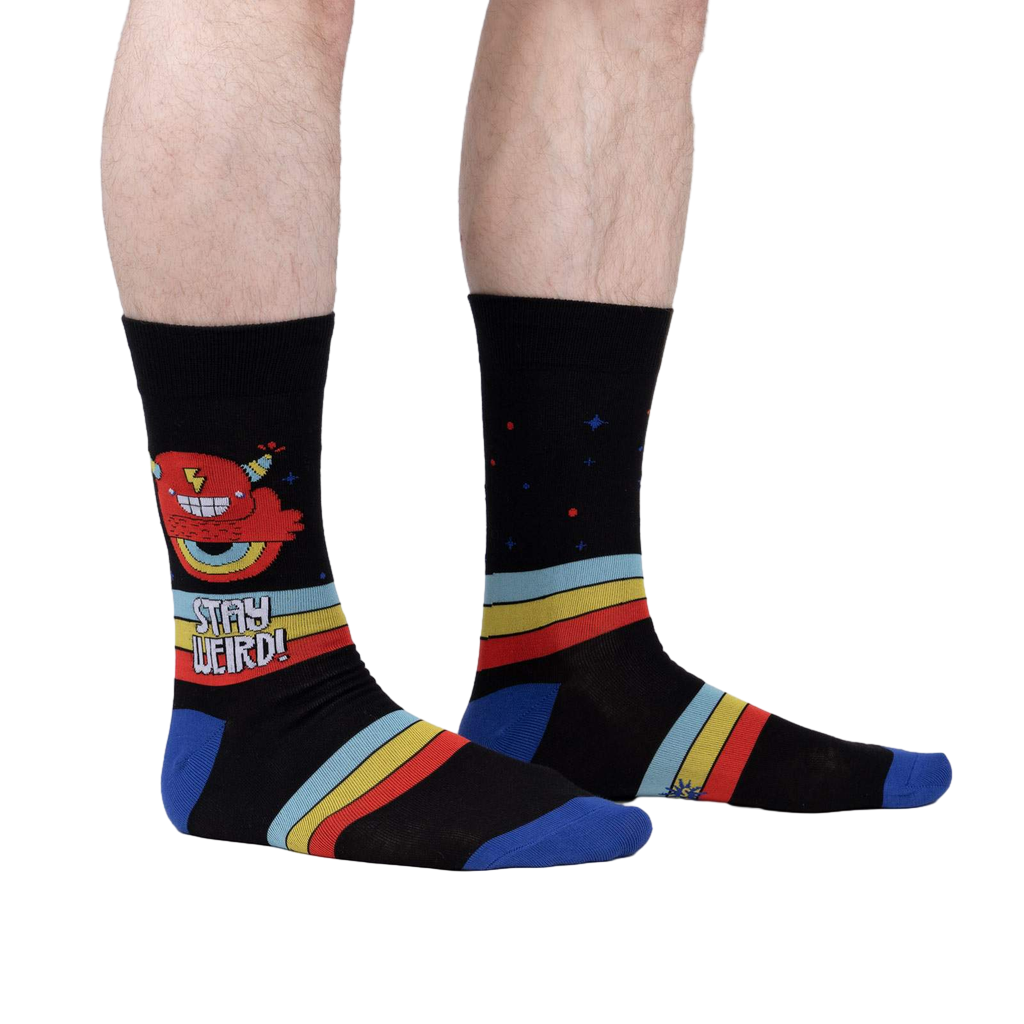 Lifestyle shot of a person wearing 'Stay Weird' socks, showing the design on the leg.