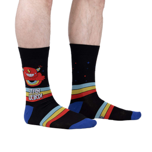 Lifestyle shot of a person wearing 'Stay Weird' socks, showing the design on the leg.