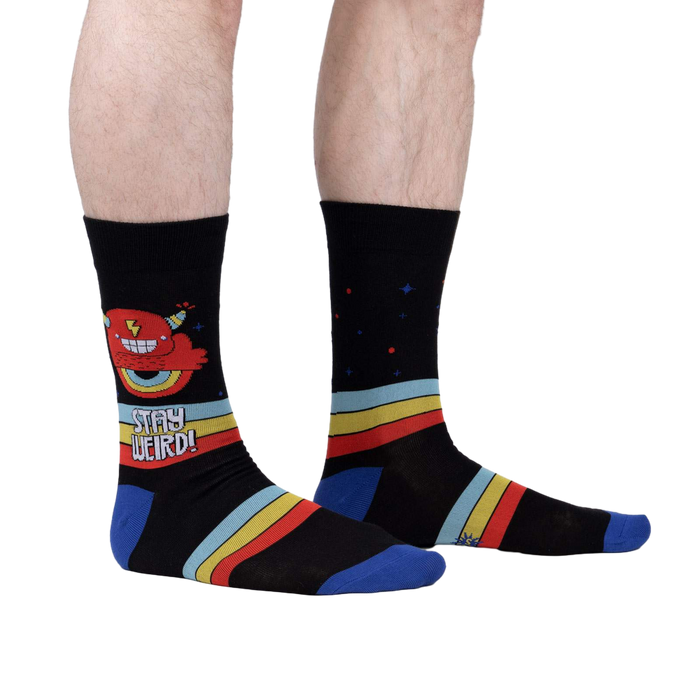 Lifestyle shot of a person wearing 'Stay Weird' socks, showing the design on the leg.