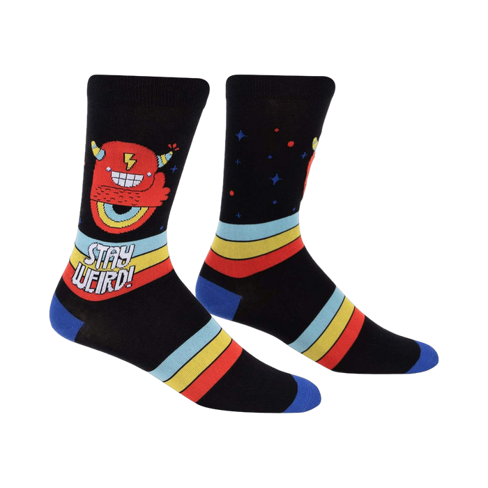 Crew socks in black with a red monster, retro stripes, and 'Stay Weird!' text.  Blue cuffs.