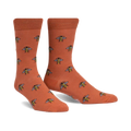 Pair of terracotta crew socks with a repeating pattern of illustrated bees. 
