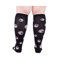 Rear view of a person wearing the All Eyes On Me Glow knee-high socks, showcasing the eyeball pattern on the back of the socks.