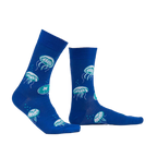 Lifestyle shot of a person wearing the 'Nice to Sea You' glow-in-the-dark jellyfish socks.