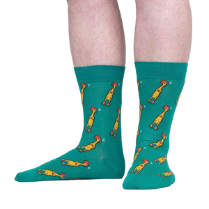 Lifestyle shot of a person wearing teal crew socks with a chicken pattern. The socks are shown from the knees down.