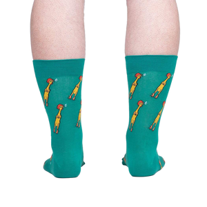 Rear view of teal crew socks with a repeating pattern of yellow chickens, showcased against a neutral gray background.