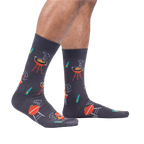 Lifestyle shot of male model wearing the 'Steaks are High' socks, showing how they look on the feet.