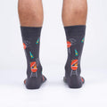 Rear view of male model wearing 'Steaks are High' socks, showcasing the design's full coverage.