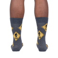 Back view of the Bigfoot Xing socks on a person's legs, showcasing the full sock design.