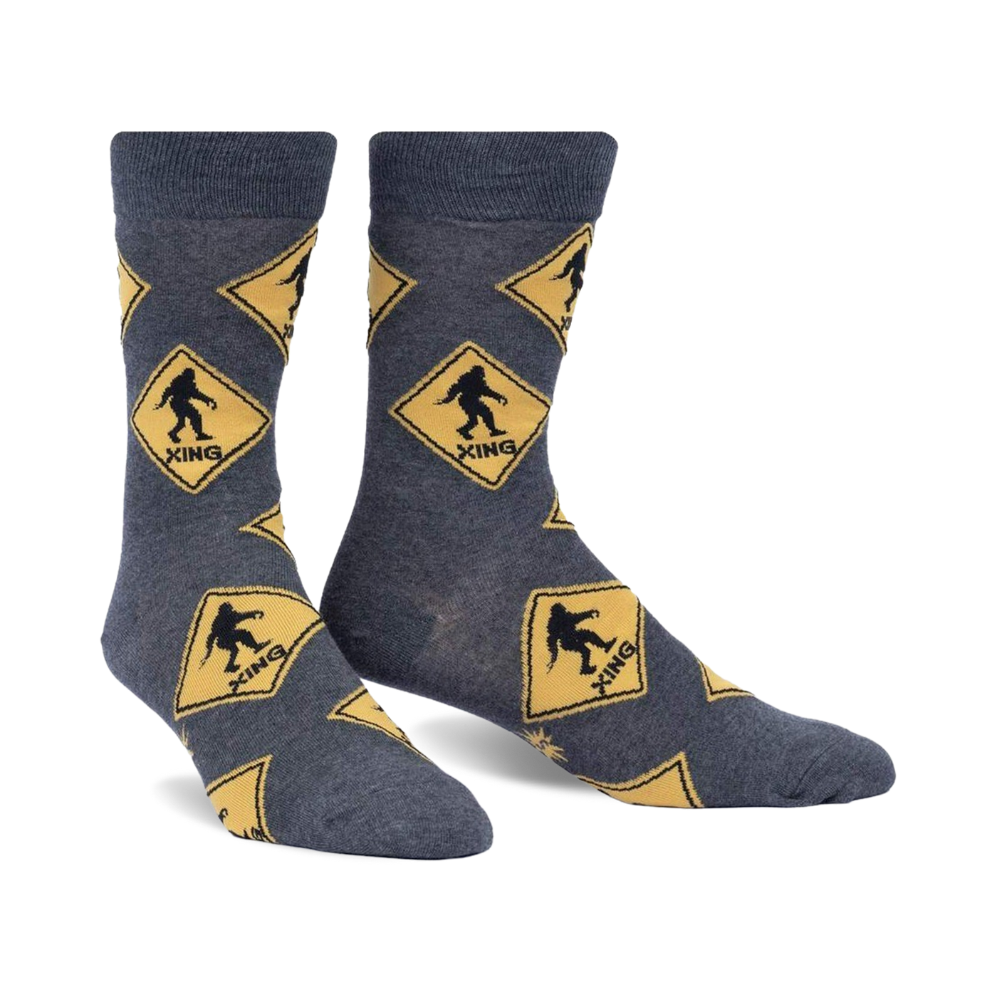 Crew socks in grey with a repeating pattern of yellow diamond-shaped Bigfoot crossing signs. Fun, quirky design.