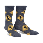 Crew socks in grey with a repeating pattern of yellow diamond-shaped Bigfoot crossing signs. Fun, quirky design.