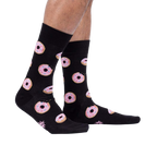 Lifestyle shot: Person wearing the Donut Stop Believing socks, showing how they look on feet.