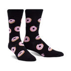 Pair of black crew socks with pink glazed donut pattern. Donuts have sprinkles and some are slightly 'bitten'.