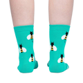 Back view of teal bee socks on a person's legs.