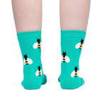 Back view of teal bee socks on a person's legs.
