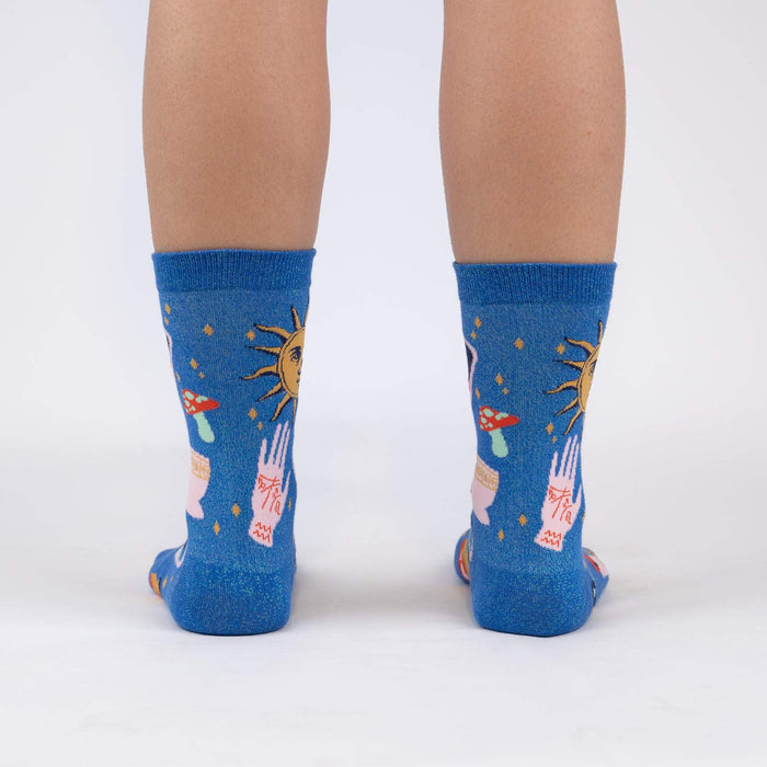 A pair of blue socks with a pattern of hands, mushrooms, stars, and suns.