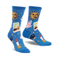 Pair of blue crew socks with a celestial design. Features suns, tarot cards, hands, candles, and crystals on a shimmering blue background.