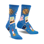 Pair of blue crew socks with a celestial design. Features suns, tarot cards, hands, candles, and crystals on a shimmering blue background.