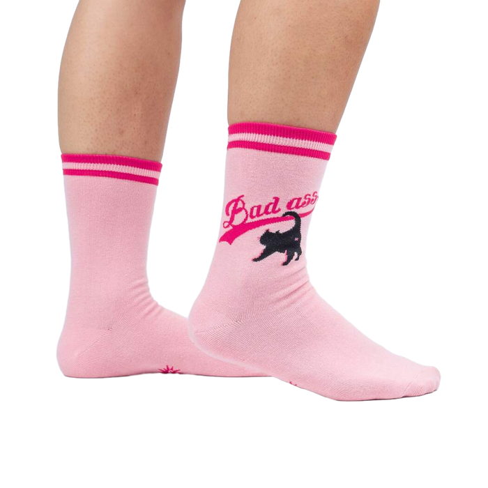 Lifestyle shot of a person wearing a pair of pink 'Bad Ass Cat' crew socks.