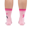 Rear view of a person's legs wearing pink 'Bad Ass Cat' socks, showing the full design on the back of the socks.