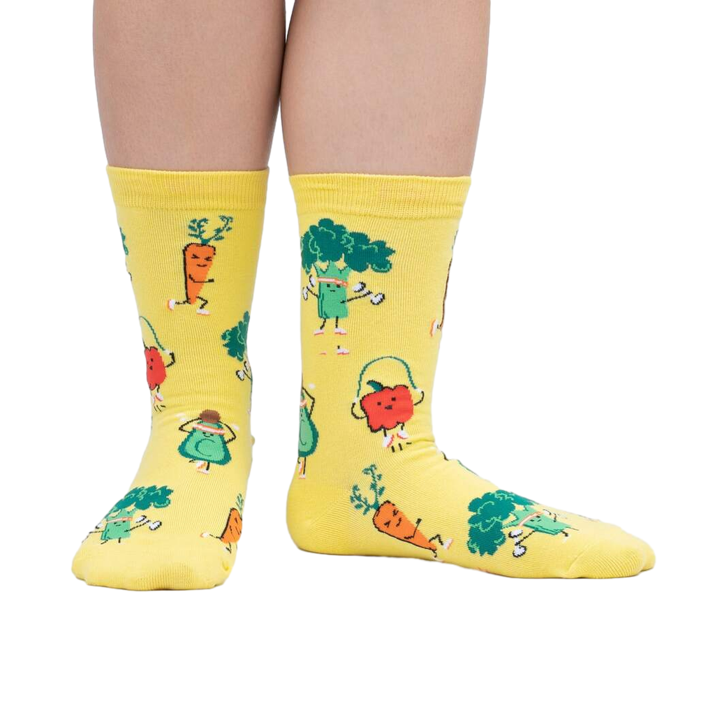 Lifestyle shot of Plant Powered socks on a person's feet, showcasing the fun design in action.