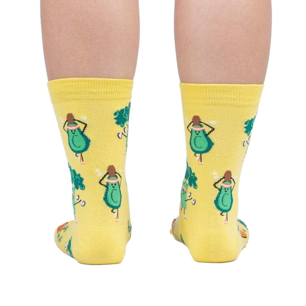Rear view of a person wearing Plant Powered socks, highlighting the design on the back of the socks.