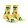 Pair of yellow crew socks featuring cartoon broccoli, carrots, avocados, and apples exercising. 