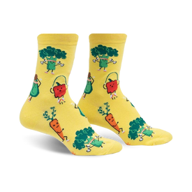 plant powered crew socks for women, featuring yellow socks with a pattern of exercising vegetables such as carrots doing yoga, aerobics avocados, and jogging red peppers. 