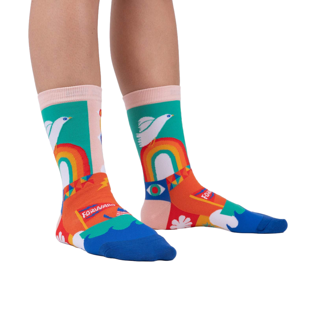 A person's legs wearing the Peace and Love socks.  Shows off the socks' vibrant colors and design in a lifestyle setting.