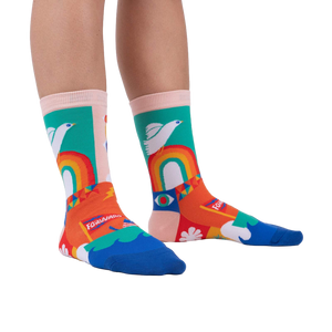 A person's legs wearing the Peace and Love socks.  Shows off the socks' vibrant colors and design in a lifestyle setting.