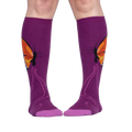 Lifestyle shot: A person is wearing purple knee-high socks with an orange butterfly design.