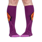 Lifestyle shot: A person is wearing purple knee-high socks with an orange butterfly design.