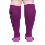 Back view of a person wearing purple knee-high socks with an orange butterfly design.