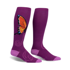 women's monarch socks in purple feature a pattern of orange, black, and blue butterflies with a flower.  