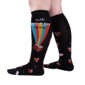 Lifestyle shot of a person wearing the 'Talk Wordy To Me' socks, showcasing how they look when worn.