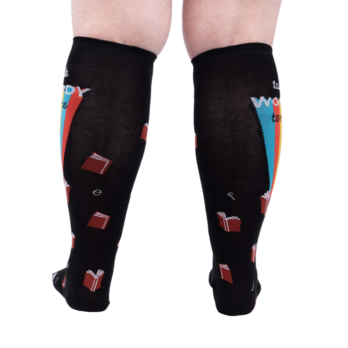 Back view of the 'Talk Wordy To Me' socks on a person's legs.  Shows the complete sock design.