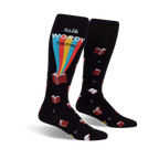 Pair of black knee-high socks with a whimsical design. Features red books, a rainbow, and the phrase 'Talk Wordy To Me'.