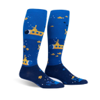 Pair of blue and yellow knee-high socks featuring yellow submarines, small fish, and bubbles. 