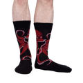 Lifestyle shot of a man's legs wearing the black octopus socks; showcasing fit and style.
