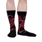Lifestyle shot of a man's legs wearing the black octopus socks; showcasing fit and style.