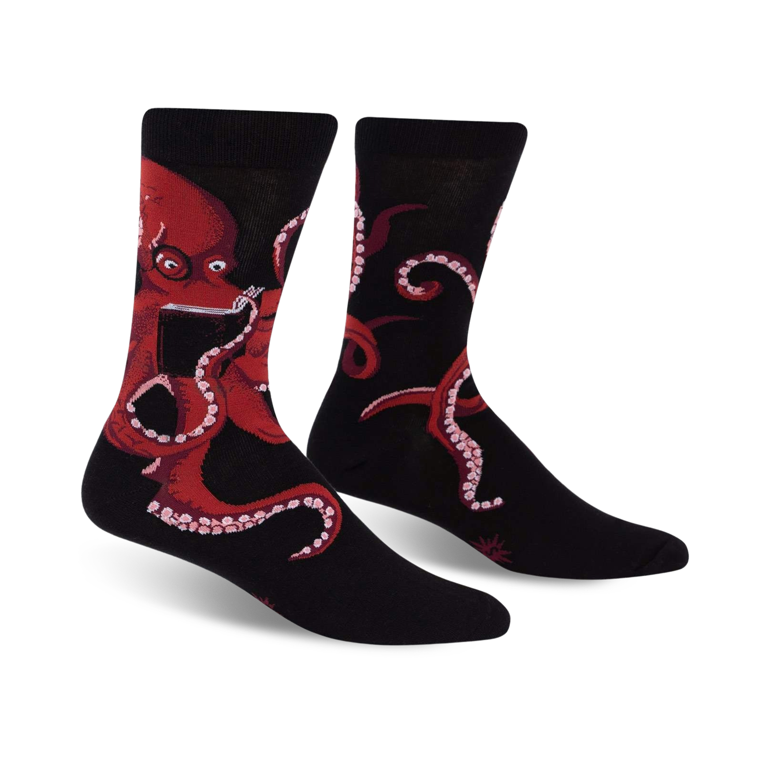 Pair of black crew socks with a red octopus reading a book; shown from the front.