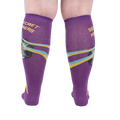 Rear view of a person wearing the purple 'Secret Powers' knee-high socks showcasing the design on the back of the socks.