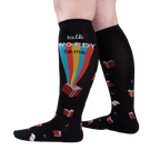 Lifestyle shot showing the socks on a person's legs, showcasing the design and fit.