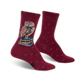 Burgundy crew socks with a brown owl wearing a bow tie and perched on a stack of books. Small diamond pattern adorns the socks.