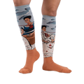 Lifestyle shot of The Two Fridas socks on a person's legs, showcasing the fit and design against a white background.